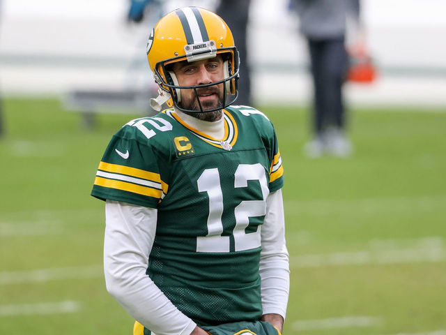 GREEN BAY, WISCONSIN - JANUARY 24: Aaron Rodgers #12 of the Green Bay Packers warms up before the NFC Championship game against the Tampa Bay Buccaneers at Lambeau Field on January 24, 2021 in Green Bay, Wisconsin.