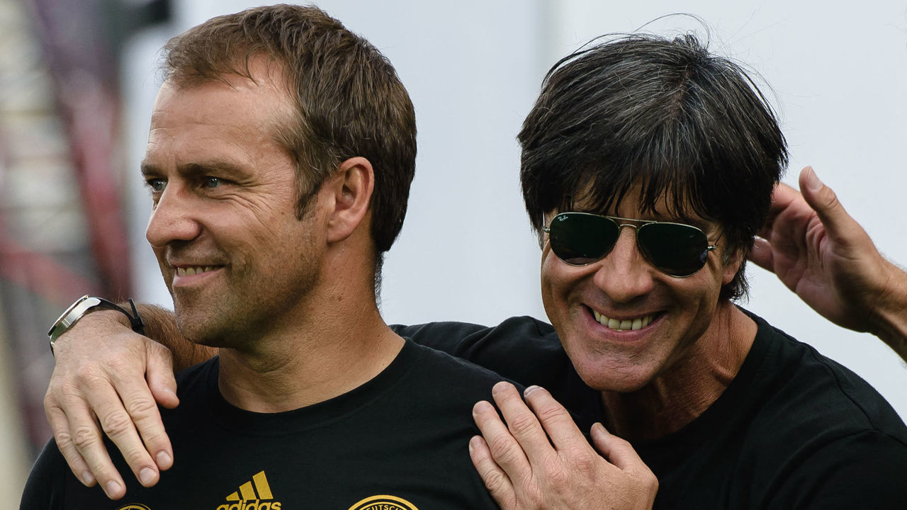 (ALTERNATIVE CROP) Picture taken on July 15, 2014 shows Germany's head coach Joachim Loew (R) and then Germany's assistant coach Hans-Dieter (Hansi) Flick celebrating during a victory parade of Germany's football national team at Berlin's landmark Brandenburg Gate to celebrate their FIFA World Cup title. - Outgoing Bayern Munich coach Hansi Flick will succeed his former boss Joachim Loew in the Germany dugout after the Euro 2020 finals, the German FA (DFB) said on May 25, 2021. - ALTERNATIVE CROP