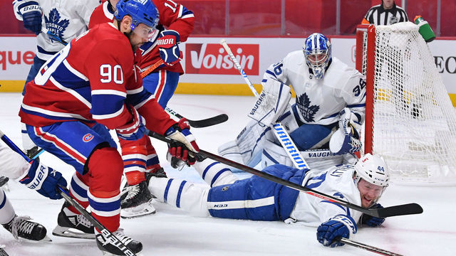 MONTREAL, QC - MAY 25: Morgan Rielly #44 of the Toronto Maple Leafs slides to clear the puck while being challenged by Tomas Tatar #90 of the Montreal Canadiens in Game Four of the First Round of the 2021 Stanley Cup Playoffs at the Bell Centre on May 25, 2021 in Montreal, Quebec, Canada.