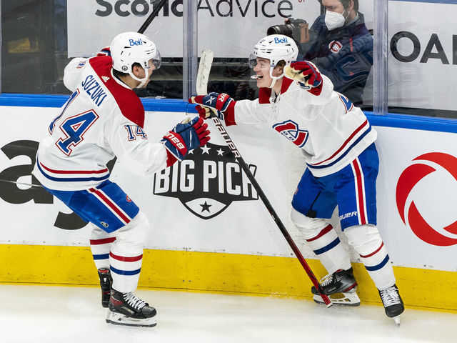 TORONTO, ON - MAY 27: Nick Suzuki #14 of the Montreal Canadiens celebrates with teammate Cole Caufield #22 after defeating the Toronto Maple Leafs in Game Five of the First Round of the 2021 Stanley Cup Playoffs at the Scotiabank Arena on May 27, 2021 in Toronto, Ontario, Canada.