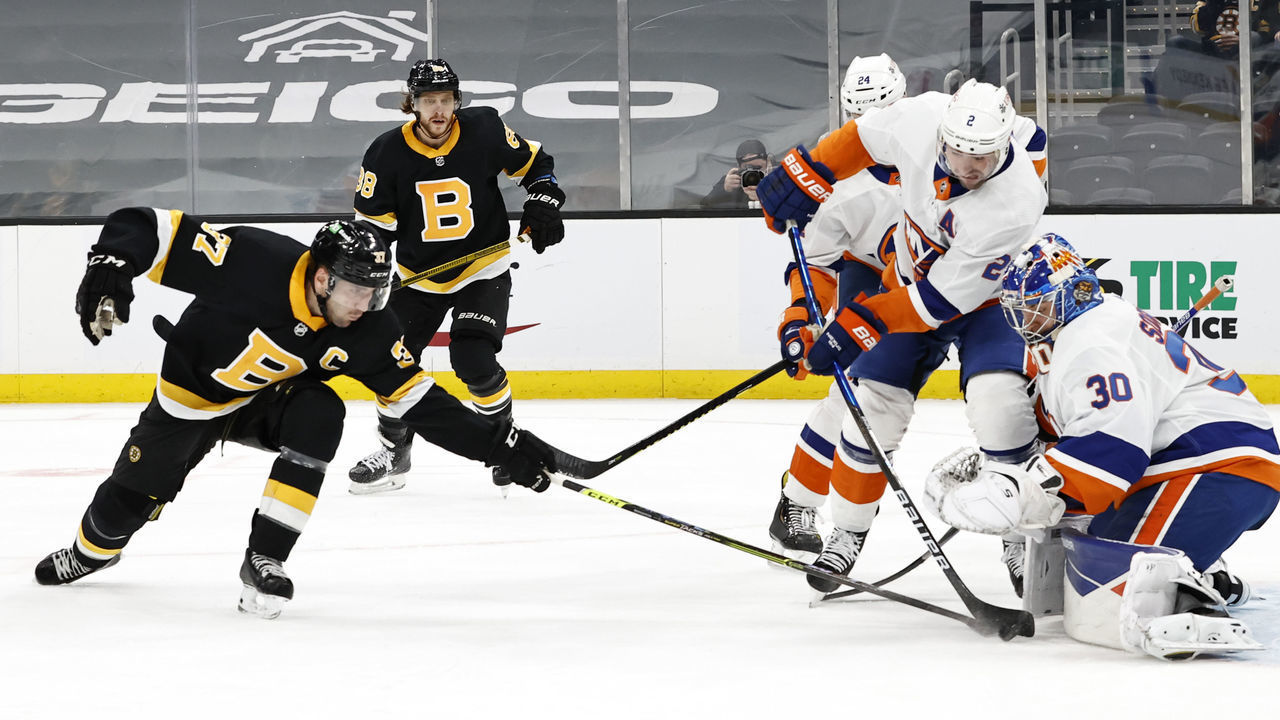 BOSTON, MA - APRIL 16: New York Islanders defenseman Nick Leddy (2) blocks Boston Bruins center Patrice Bergeron (37) from getting a shot on New York Islanders goalie Ilya Sorokin (30) during a game between the Boston Bruins and the New York Islanders on April 16, 2021 at TD garden in Boston, Massachusetts.