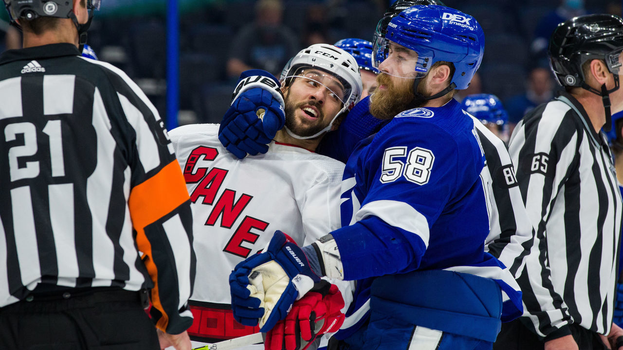 TAMPA, FL - APRIL 20: David Savard #58 of the Tampa Bay Lightning during a post whistle scrum against Vincent Trocheck #16 of the Carolina Hurricanes during the second period at Amalie Arena on April 20, 2021 in Tampa, Florida.