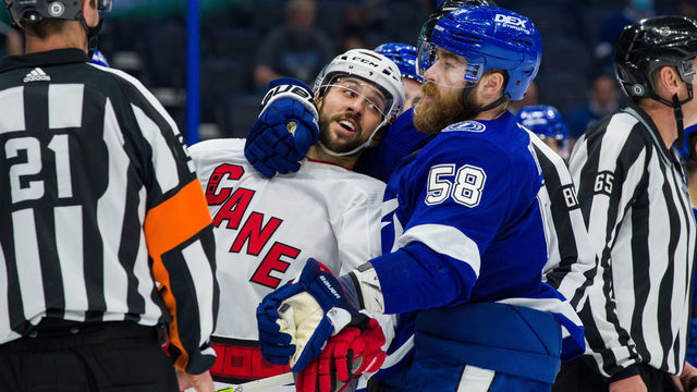 TAMPA, FL - APRIL 20: David Savard #58 of the Tampa Bay Lightning during a post whistle scrum against Vincent Trocheck #16 of the Carolina Hurricanes during the second period at Amalie Arena on April 20, 2021 in Tampa, Florida.