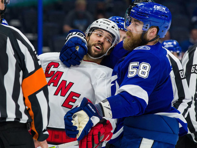 TAMPA, FL - APRIL 20: David Savard #58 of the Tampa Bay Lightning during a post whistle scrum against Vincent Trocheck #16 of the Carolina Hurricanes during the second period at Amalie Arena on April 20, 2021 in Tampa, Florida.