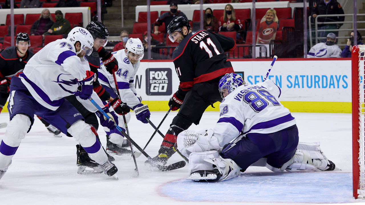 RALEIGH, NC - MARCH 27: Jordan Staal #11 of the Carolina Hurricanes looks to backhand a puck in the crease past goaltender Andrei Vasilevskiy #88 of the Tampa Bay Lightning Shot makes the save during an NHL game on March 27, 2021 at PNC Arena in Raleigh, North Carolina.