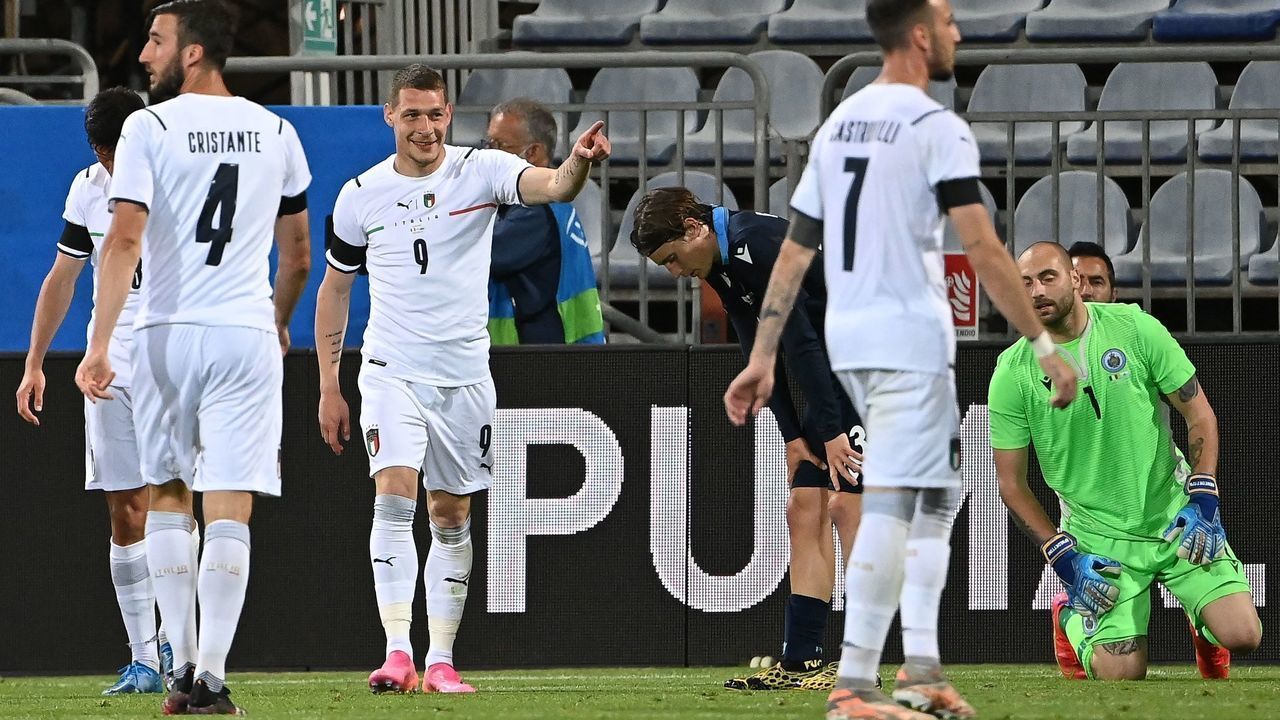 Italy's forward Andrea Belotti (L) reacts after scoring a goal during a friendly football match between Italy and San Marino at the Sardegna Arena in Cagliari on May 28, 2021, in preparation for the UEFA Euro 2020 European Football Championship.