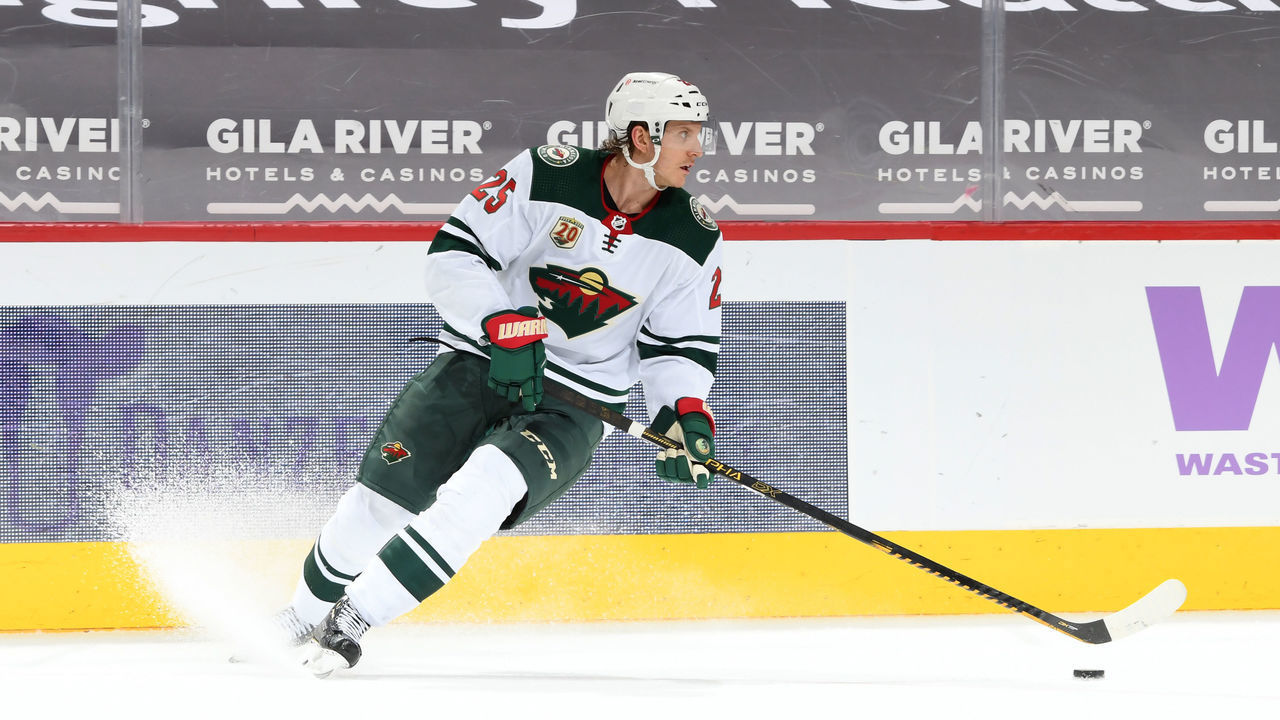 GLENDALE, ARIZONA - APRIL 19: Jonas Brodin #25 of the Minnesota Wild skates the puck up ice against the Arizona Coyotes at Gila River Arena on April 19, 2021 in Glendale, Arizona.