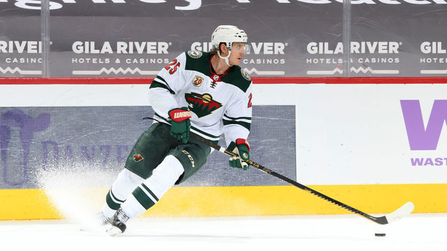 GLENDALE, ARIZONA - APRIL 19: Jonas Brodin #25 of the Minnesota Wild skates the puck up ice against the Arizona Coyotes at Gila River Arena on April 19, 2021 in Glendale, Arizona.