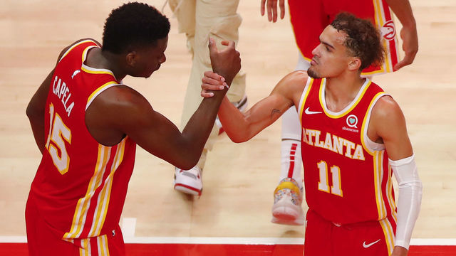 ATLANTA, GA - MAY 28: Trae Young #11 reacts with Clint Capela #15 of the Atlanta Hawks at the conclusion of the game against the New York Knicks in game three of the Eastern Conference Quarterfinals at State Farm Arena on May 28, 2021 in Atlanta, Georgia. NOTE TO USER: User expressly acknowledges and agrees that, by downloading and/or using this photograph, user is consenting to the terms and conditions of the Getty Images License Agreement.