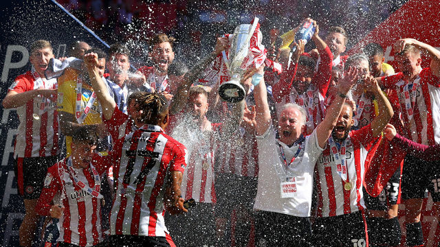 LONDON, ENGLAND - MAY 29: Brentford players celebrate with the Sky Bet Championship Play-off Final trophy after victory in the Sky Bet Championship Play-off Final between Brentford FC and Swansea City at Wembley Stadium on May 29, 2021 in London, England.
