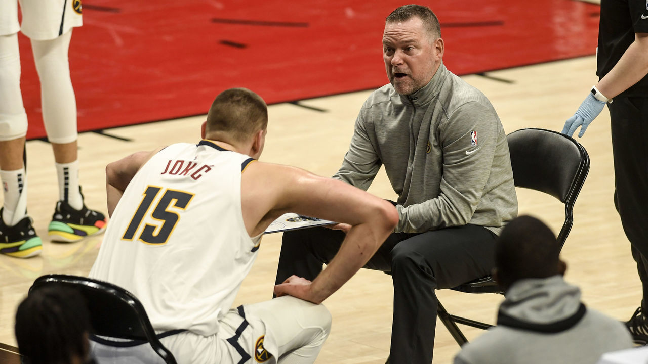 PORTLAND, OR - MAY 29: Nikola Jokic (15) and Denver Nuggets head coach Michael Malone strategize against the Portland Trail Blazers during the first quarter at Moda Center on Saturday, May 29, 2021.