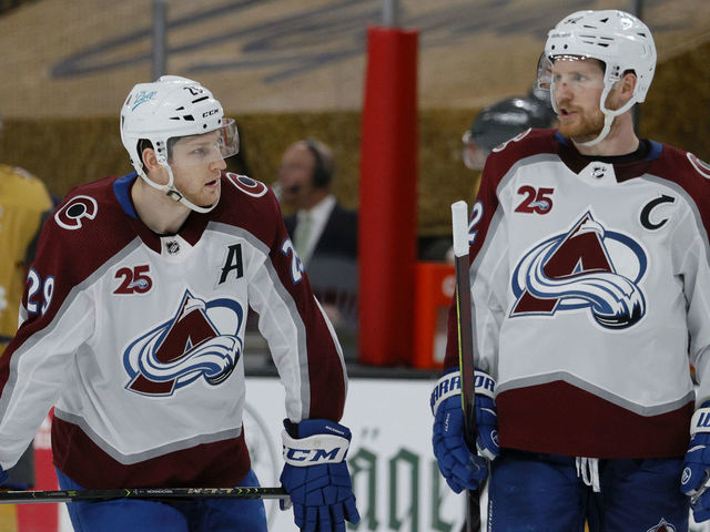 LAS VEGAS, NEVADA - APRIL 28: Nathan MacKinnon #29 and Gabriel Landeskog #92 of the Colorado Avalanche talk during a break in the third period of their game against the Vegas Golden Knights at T-Mobile Arena on April 28, 2021 in Las Vegas, Nevada. The Golden Knights defeated the Avalanche 5-2.