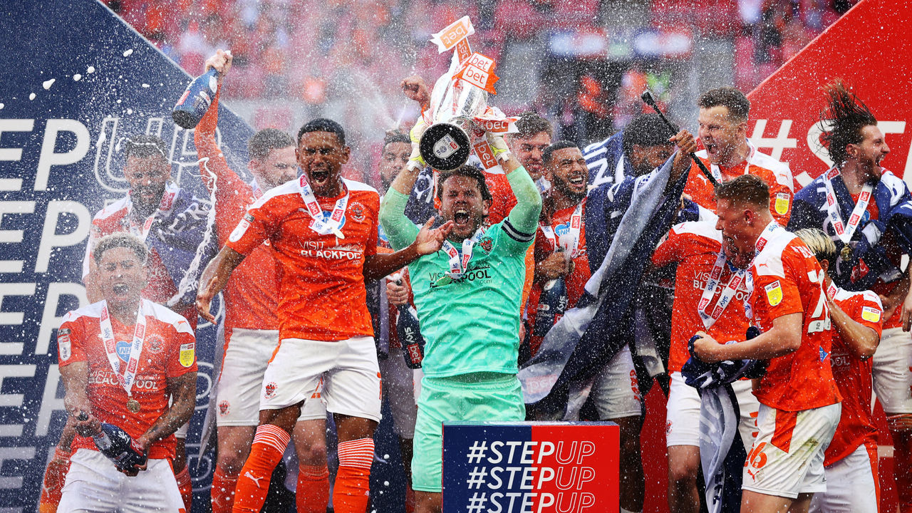 LONDON, ENGLAND - MAY 30: Chris Maxwell of Blackpool lifts the Sky Bet League One Play-off Trophy as his team mates celebrate following victory in the Sky Bet League One Play-off Final match between Blackpool and Lincoln City at Wembley Stadium on May 30, 2021 in London, England.