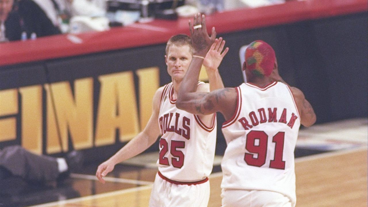 13 Jun 1997: Guard Shandon Anderson of the Utah Jazz watches as guard Steve Kerr #25 and forward Dennis Rodman #91 of the Chicago Bulls high five each other during game 6 of the 1997 NBA Finals at the United Center in Chicago, Illinois. The Bulls defeated the Jazz 90-86 to win the series and claim the championship.