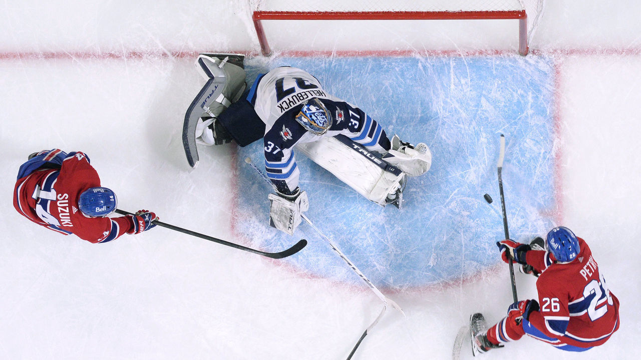 MONTREAL, QC - APRIL 30: Connor Hellebuyck #37 of the Winnipeg Jets defends the goal against Jeff Petry #26 of the Montreal Canadiens in the NHL game at the Bell Centre on April 30, 2021 in Montreal, Quebec, Canada.
