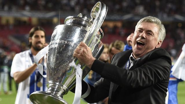 Real Madrid's Italian coach Carlo Ancelotti celebrates their victory with the trophy at the end of the UEFA Champions League Final Real Madrid vs Atletico de Madrid at Luz stadium in Lisbon, on May 24, 2014. Real Madrid won 4-1. AFP PHOTO/ FRANCK FIFE / AFP PHOTO / Franck FIFE