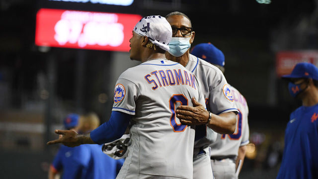 PHOENIX, ARIZONA - JUNE 01: Marcus Stroman #0 of the New York Mets is held back by bullpen coach Ricky Bones #25 during an argument with the Arizona Diamondbacks during the sixth inning at Chase Field on June 01, 2021 in Phoenix, Arizona.
