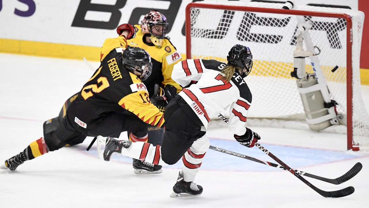 Laura Stacey of Canada (R) scores her team's third goal during the quarterfinal match Canada vs Germany of the IIHF Women's Ice Hockey World Championships in Espoo, Finland on April 11, 2019.