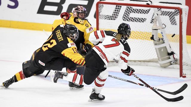 Laura Stacey of Canada (R) scores her team's third goal during the quarterfinal match Canada vs Germany of the IIHF Women's Ice Hockey World Championships in Espoo, Finland on April 11, 2019.