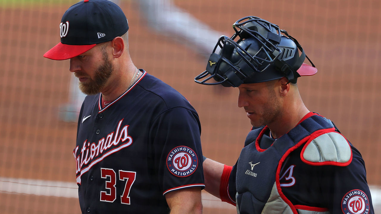 ATLANTA, GEORGIA - JUNE 01: Stephen Strasburg #37 and Yan Gomes #10 of the Washington Nationals walk off the field after the first inning against the Atlanta Braves at Truist Park on June 01, 2021 in Atlanta, Georgia.