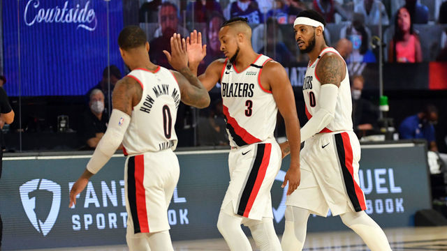 Orlando, FL - AUGUST 8: Damian Lillard #0 of the Portland Trail Blazers, CJ McCollum #3 of the Portland Trail Blazers, and Carmelo Anthony #00 of the Portland Trail Blazers look on during the game against the LA Clippers on August 8, 2020 at The Field House at ESPN Wide World Of Sports Complex in Orlando, Florida. NOTE TO USER: User expressly acknowledges and agrees that, by downloading and/or using this Photograph, user is consenting to the terms and conditions of the Getty Images License Agreement. Mandatory Copyright Notice: Copyright 2020 NBAE