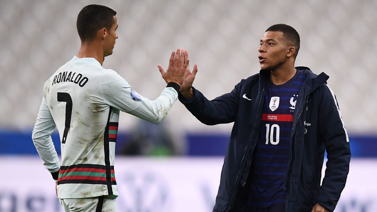 Portugal's forward Cristiano Ronaldo (L) greets France's forward Kylian Mbappe at the end of the Nations League football match between France and Portugal, on October 11, 2020 at the Stade de France in Saint-Denis, outside Paris.