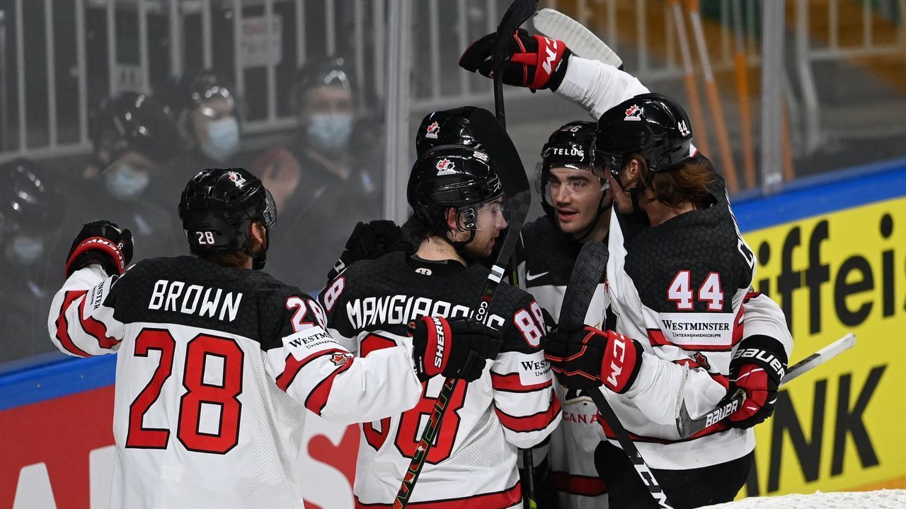 Canada's forward Andrew Mangiapane (C) celebrates with teammates after scoring the 1-3 goal during the IIHF Men's Ice Hockey World Championships semi-final match between the USA and Canada at the Arena Riga in Riga, Latvia, on June 5, 2021.