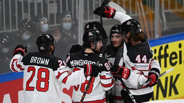 Canada's forward Andrew Mangiapane (C) celebrates with teammates after scoring the 1-3 goal during the IIHF Men's Ice Hockey World Championships semi-final match between the USA and Canada at the Arena Riga in Riga, Latvia, on June 5, 2021.