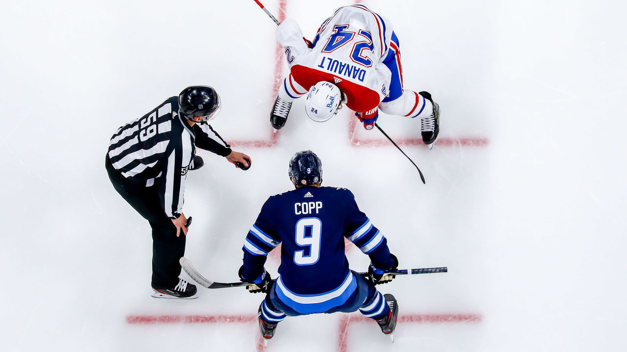WINNIPEG, MB - JUNE 4: Phillip Danault #24 of the Montreal Canadiens gets set to take a second period face-off against Andrew Copp #9 of the Winnipeg Jets in Game Two of the Second Round of the 2021 Stanley Cup Playoffs at the Bell MTS Place on June 4, 2021 in Winnipeg, Manitoba, Canada.