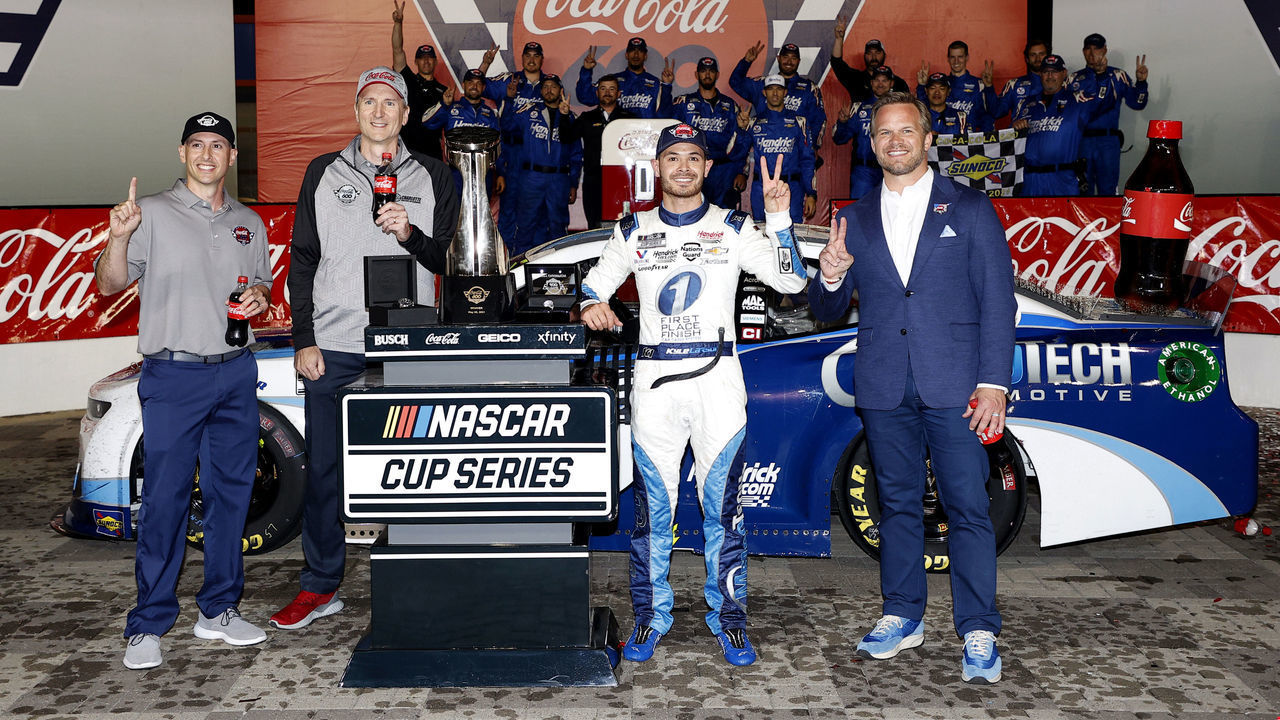 CONCORD, NORTH CAROLINA - MAY 30: Kyle Larson, driver of the #5 Metro Tech Chevrolet, and Marcus Smith, Speedway Motorsports, Inc., President & CEO (R) celebrate in victory lane after winning the NASCAR Cup Series Coca-Cola 600, Hendrick Motorsports' 269th Cup Series win, the most in NASCAR at Charlotte Motor Speedway on May 30, 2021 in Concord, North Carolina.