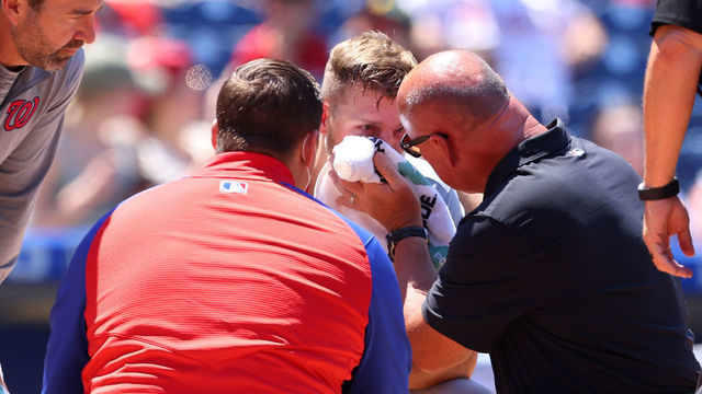 PHILADELPHIA, PA - JUNE 06: Austin Voth #50 of the Washington Nationals has a compress held to his face after getting hit by a pitch on an attempted bunt against the Philadelphia Phillies during the third inning of a game at Citizens Bank Park on June 6, 2021 in Philadelphia, Pennsylvania.