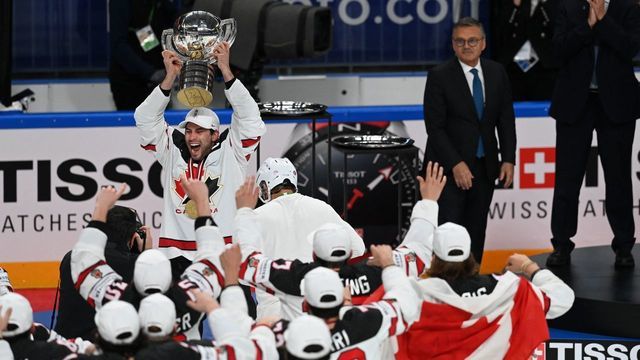 Canada's forward Adam Henrique (top L) holds up the trophy as Canada's players celebrate with the trophy after winning the IIHF Men's Ice Hockey World Championships final match between the Finland and Canada at the Arena Riga in Riga, Latvia, on June 5, 2021. - A 3-2 victory over Finland crowned Canada Ice Hockey World Champions 2021.