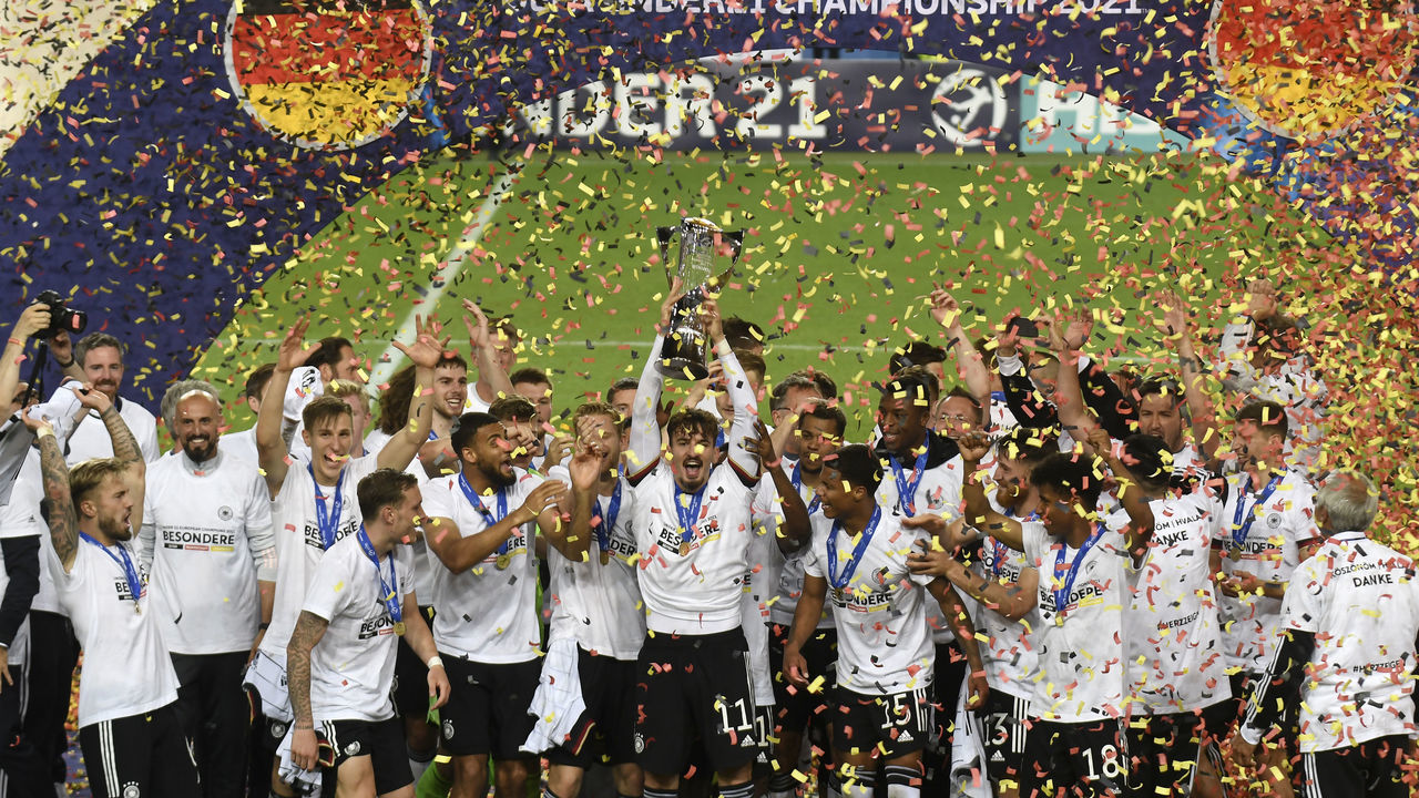 LJUBLJANA, SLOVENIA - JUNE 06: Mergim Berisha of Germany lifts the UEFA European Under-21 Championship trophy in celebration with team mates after winning the 2021 UEFA European Under-21 Championship Final match between Germany and Portugal at Stadion Stozice on June 06, 2021 in Ljubljana, Slovenia.
