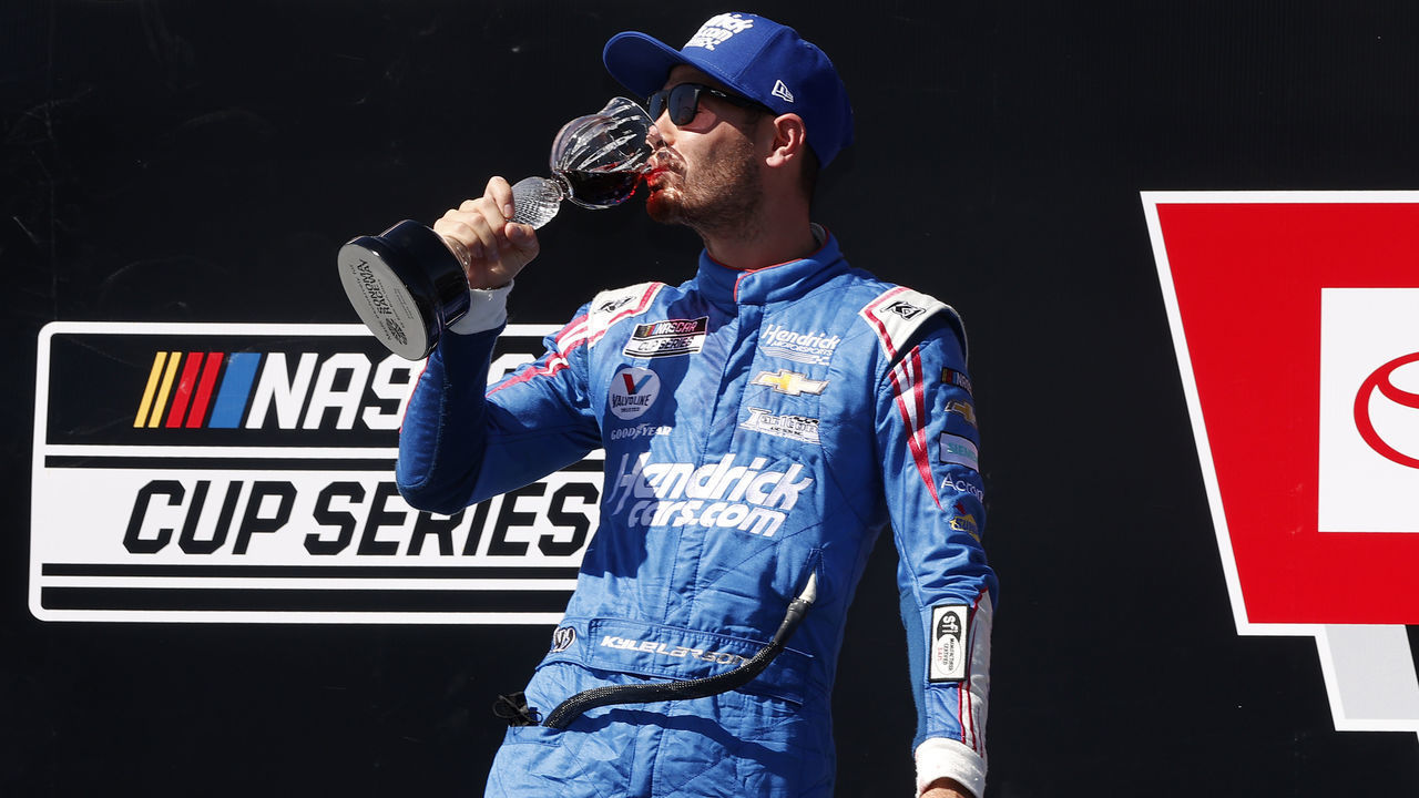 SONOMA, CALIFORNIA - JUNE 06: Kyle Larson, driver of the #5 HendrickCars.com Chevrolet, celebrates in victory lane by drinking wine after winning the NASCAR Cup Series Toyota/Save Mart 350 at Sonoma Raceway on June 06, 2021 in Sonoma, California.