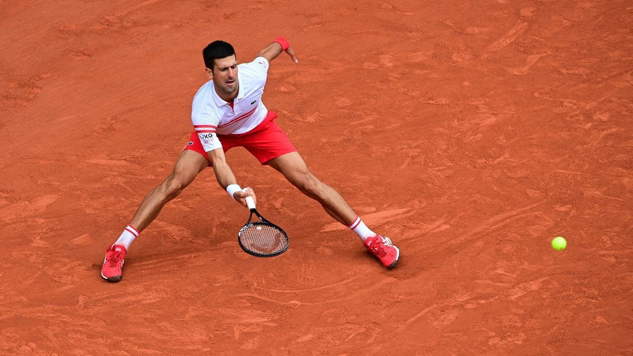 Serbia's Novak Djokovic returns the ball to Italy's Lorenzo Musetti during their men's singles fourth round tennis match on Day 9 of The Roland Garros 2021 French Open tennis tournament in Paris on June 7, 2021.