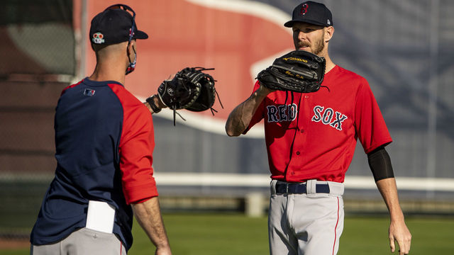 FT. MYERS, FL - FEBRUARY 21: Chris Sale #41 of the Boston Red Sox high fives pitching coach Dave Bush after throwing during a spring training team workout on February 21, 2021 at jetBlue Park at Fenway South in Fort Myers, Florida.