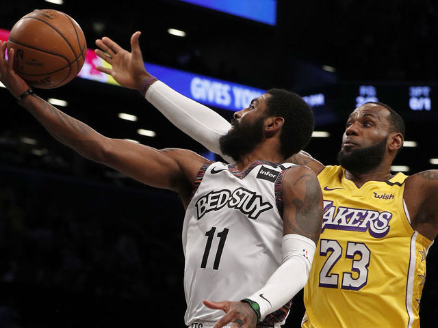NEW YORK, NEW YORK - JANUARY 23: (NEW YORK DAILIES OUT) Kyrie Irving #11 of the Brooklyn Nets in action against LeBron James #23 of the Los Angeles Lakers at Barclays Center on January 23, 2020 in New York City. The Lakers defeated the Nets 128-113.