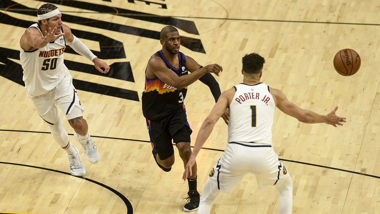 PHOENIX, AZ - JUNE 7: Chris Paul (3) of the Phoenix Suns passes as Michael Porter Jr. (1) and Aaron Gordon (50) of the Denver Nuggets defend during the third quarter at Phoenix Suns Arena on Monday, June 7, 2021. The Phoenix Suns hosted the Denver Nuggets for game one of their best-of-seven NBA Playoffs series.