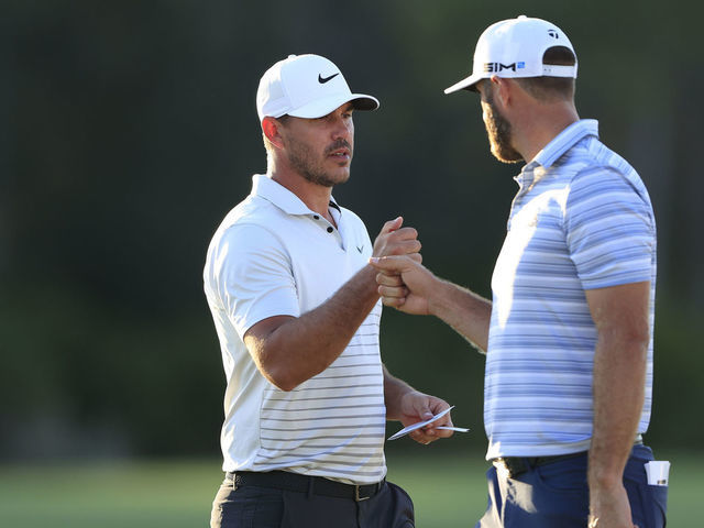 BRADENTON, FLORIDA - FEBRUARY 26: (L-R) Brooks Koepka of the United States and Dustin Johnson of the United States fist bump on the 18th green during the second round of World Golf Championships-Workday Championship at The Concession on February 26, 2021 in Bradenton, Florida.