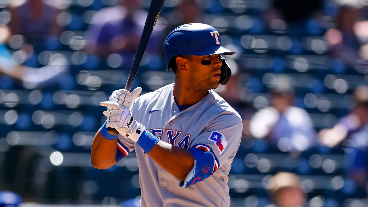 DENVER, CO - JUNE 3: Khris Davis #4 of the Texas Rangers bats during the seventh inning against the Colorado Rockies at Coors Field on June 3, 2021 in Denver, Colorado.