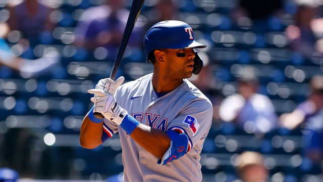 DENVER, CO - JUNE 3: Khris Davis #4 of the Texas Rangers bats during the seventh inning against the Colorado Rockies at Coors Field on June 3, 2021 in Denver, Colorado.