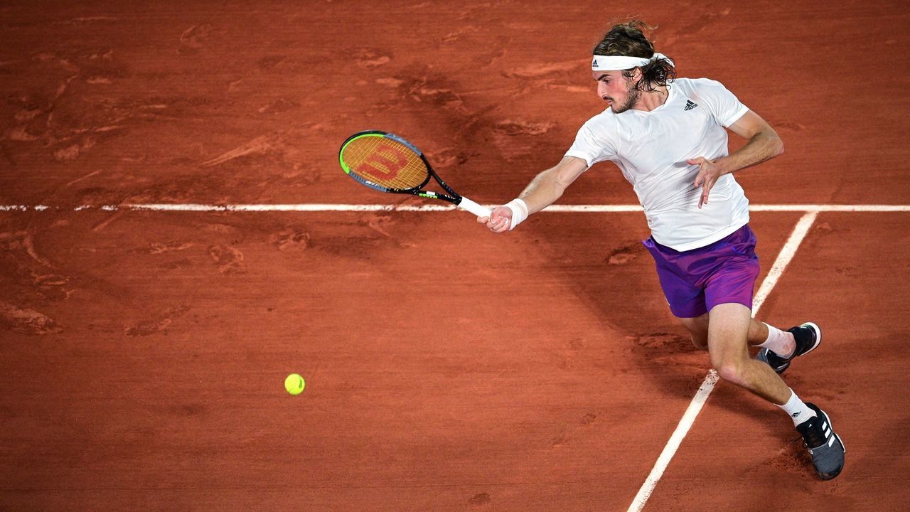 Greece's Stefanos Tsitsipas returns the ball to Russia's Daniil Medvedev during their men's singles quarter-final tennis match on Day 10 of The Roland Garros 2021 French Open tennis tournament in Paris on June 8, 2021.