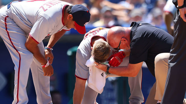 PHILADELPHIA, PA - JUNE 06: Austin Voth #50 of the Washington Nationals has a compress held to his face after getting hit by a pitch on an attempted bunt against the Philadelphia Phillies during the third inning of a game at Citizens Bank Park on June 6, 2021 in Philadelphia, Pennsylvania.