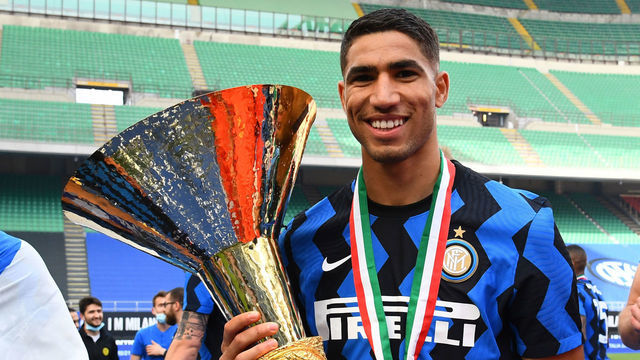 MILAN, ITALY - MAY 23: Achraf Hakimi of FC Internazionale poses with the trophy for the victory of "scudetto" at the end of the last Serie A match between FC Internazionale Milano and Udinese Calcio at Stadio Giuseppe Meazza on May 23, 2021 in Milan, Italy. Sporting stadiums around Italy remain under strict restrictions due to the Coronavirus Pandemic as Government social distancing laws prohibit fans inside venues resulting in games being played behind closed doors