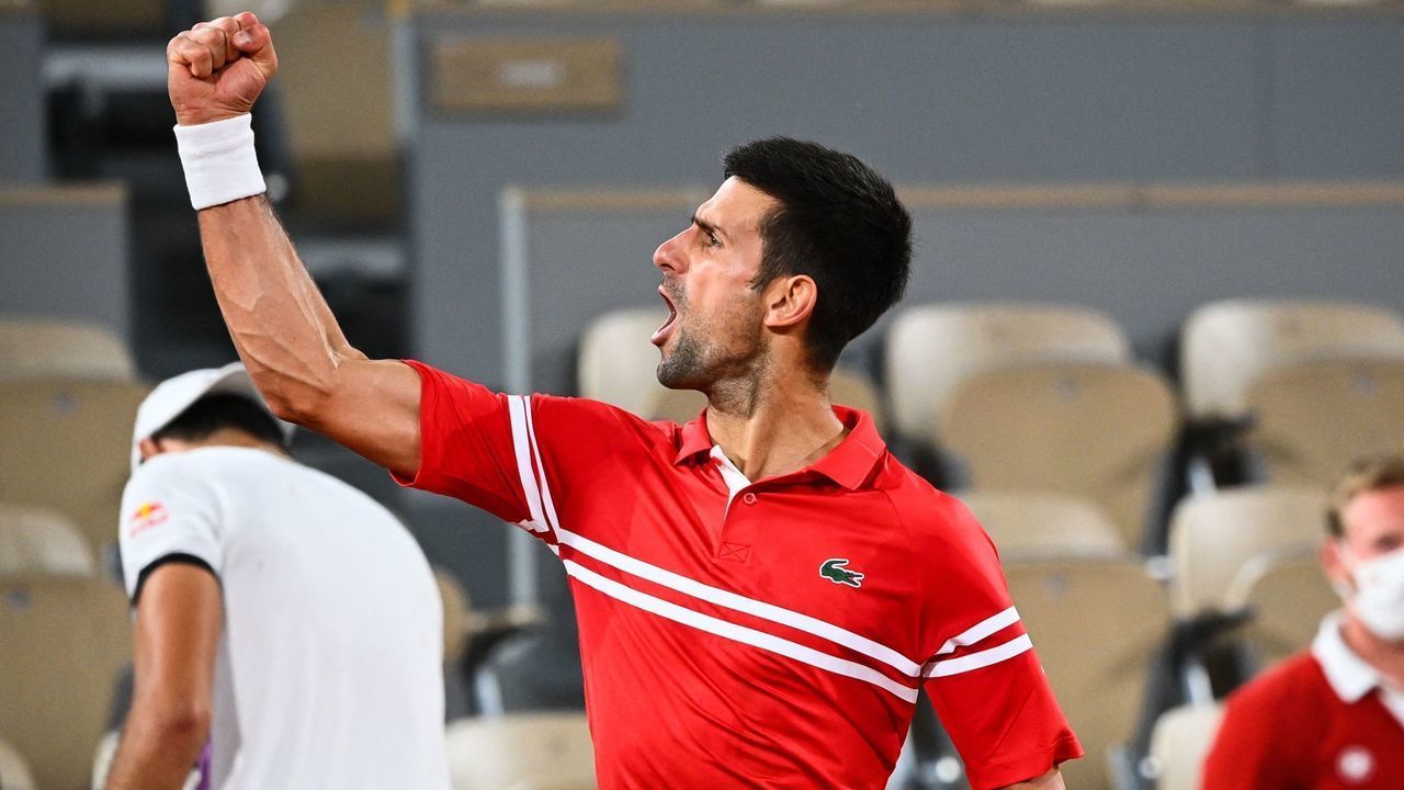 Serbia's Novak Djokovic celebrates after winning against Italy's Matteo Berrettini during their men's singles quarter-final tennis match on Day 11 of The Roland Garros 2021 French Open tennis tournament in Paris on June 9, 2021.