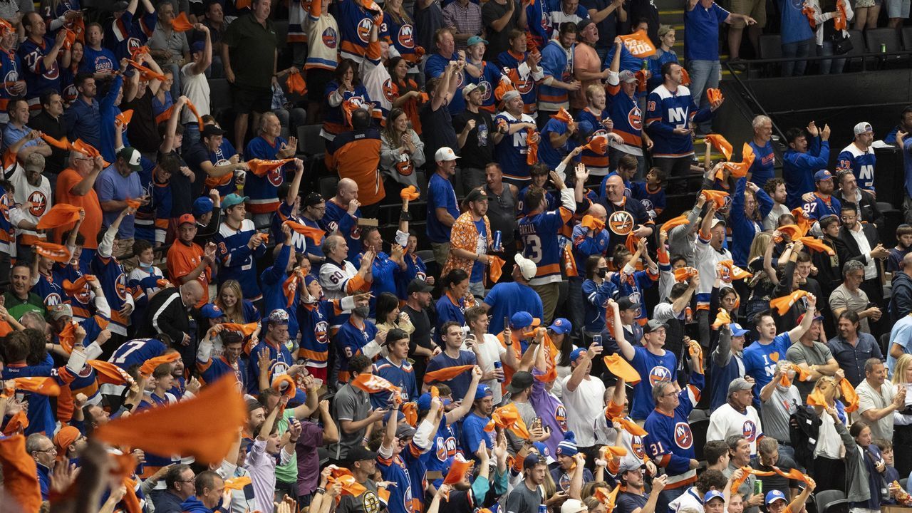 UNIONDALE, NY - JUNE 09: New York Islanders fans cheer and wave their towels during the second period of Game 6 of the NHL Stanley Cup Playoffs Second Round between the Boston Bruins and the New York Islanders on June 9, 2021, at the Nassau Veterans Memorial Coliseum in Uniondale, NY.