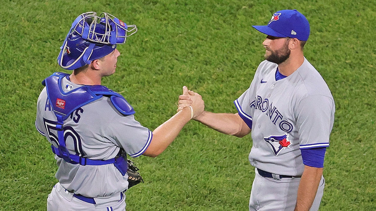CHICAGO, ILLINOIS - JUNE 09: Riley Adams #50 (L) and Tim Mayza #58 of the Toronto Blue Jays celebrate a win over the Chicago White Sox at Guaranteed Rate Field on June 09, 2021 in Chicago, Illinois. The Blue Jays defeated the White Sox 6-2.