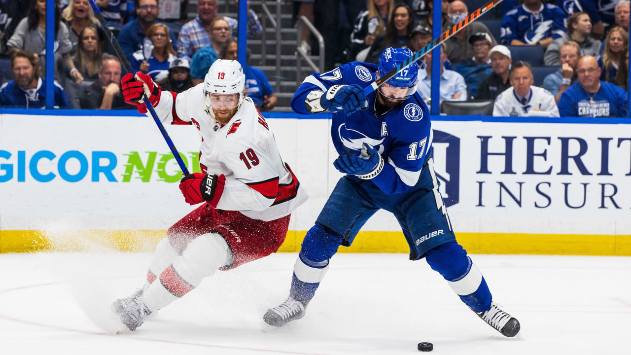 TAMPA, FL - June 3: Alex Killorn #17 of the Tampa Bay Lightning battles for the puck against Dougie Hamilton #19 of the Carolina Hurricanes during the third period in Game Three of the Second Round of the 2021 Stanley Cup Playoffs at Amalie Arena on June 3, 2021 in Tampa, Florida.
