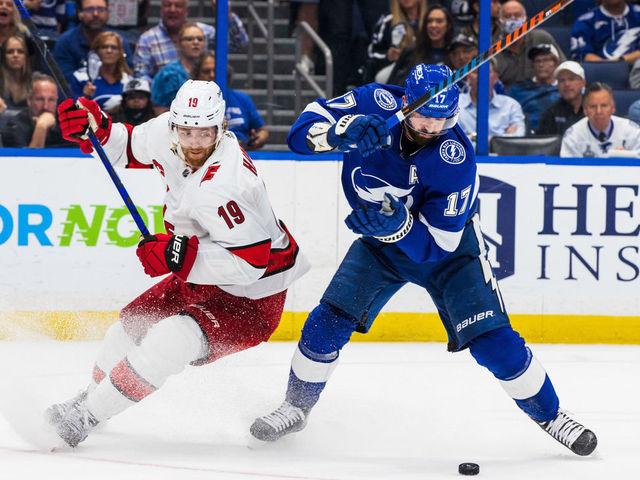 TAMPA, FL - June 3: Alex Killorn #17 of the Tampa Bay Lightning battles for the puck against Dougie Hamilton #19 of the Carolina Hurricanes during the third period in Game Three of the Second Round of the 2021 Stanley Cup Playoffs at Amalie Arena on June 3, 2021 in Tampa, Florida.