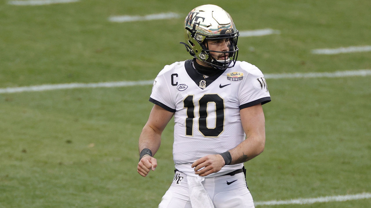 CHARLOTTE, NORTH CAROLINA - DECEMBER 30: Quarterback Sam Hartman #10 of the Wake Forest Demon Deacons reacts following a touchdown pass to teammate wide receiver Jaquarii Roberson #5 against the Wisconsin Badgers during the first quarter of the Duke's Mayo Bowl at Bank of America Stadium on December 30, 2020 in Charlotte, North Carolina.
